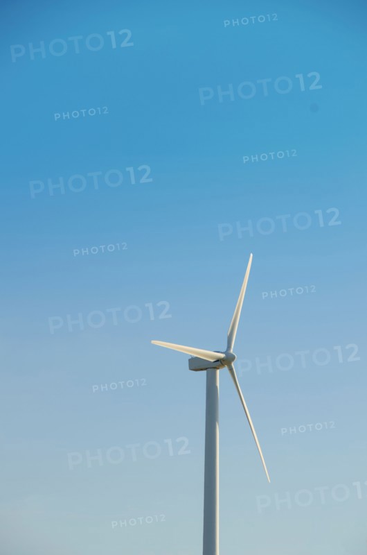 Turkey, Cesme, wind turbine against blue sky. Photo : Tetra Images