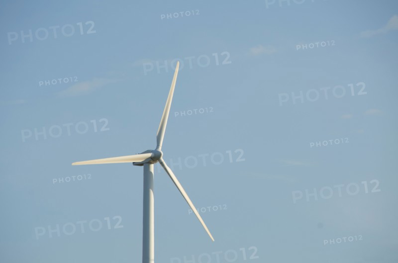 Turkey, Izmir, wind turbine against blue sky. Photo : Tetra Images