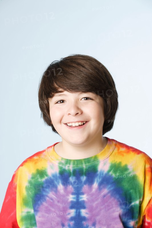 Studio portrait of boy (10-11) in colorful shirt. Photo: Rob Lewine