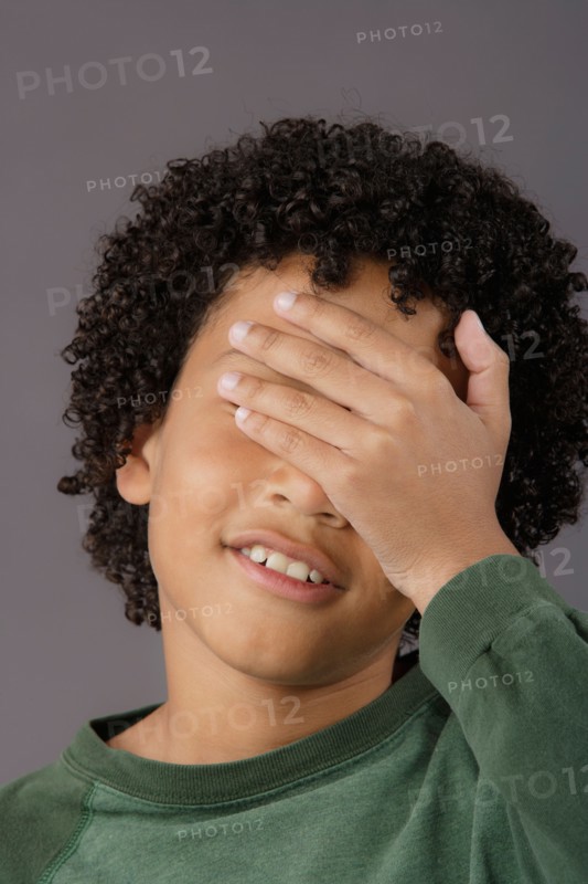 Portrait of surprised boy (8-9), studio shot. Photo: Rob Lewine