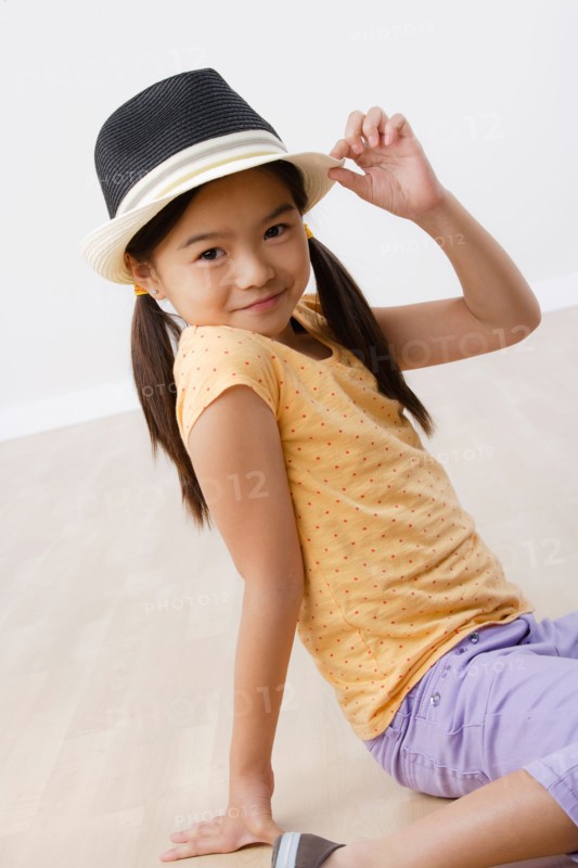 Studio portrait of girl (8-9) wearing hat. Photo: Rob Lewine