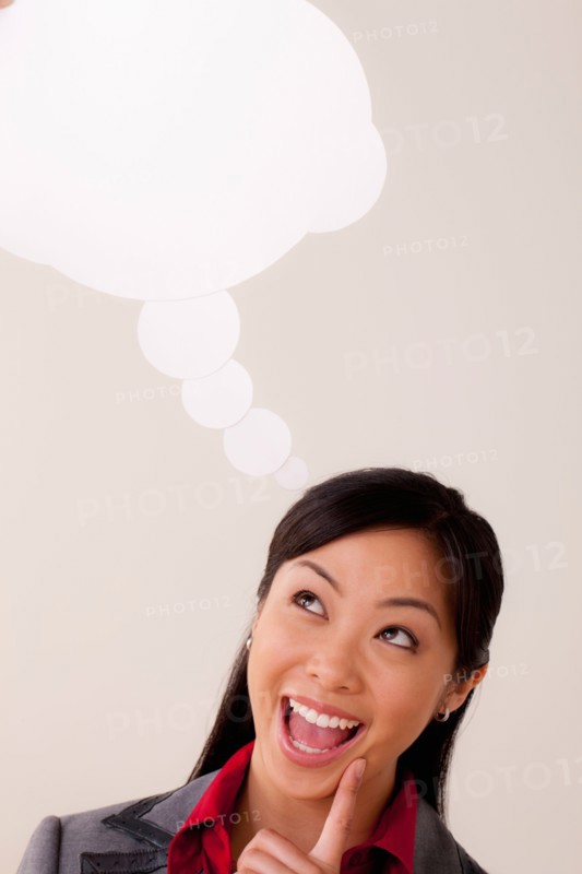 Studio portrait of businesswoman with thought bubble. Photo: Rob Lewine