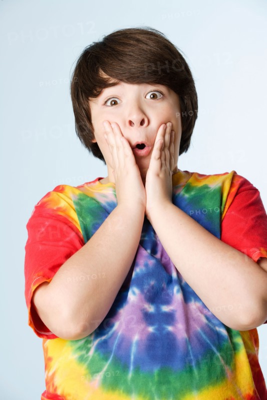 Studio portrait of boy (10-11) in colorful shirt. Photo : Rob Lewine