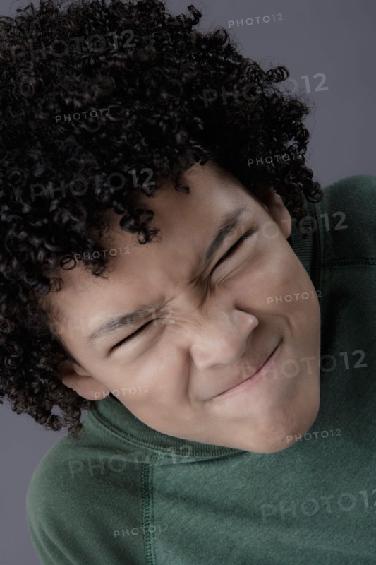Portrait of boy (8-9) looking angry, studio shot. Photo : Rob Lewine