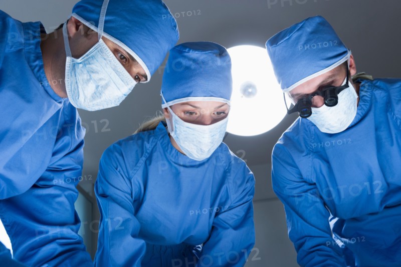 Three surgeons operating.