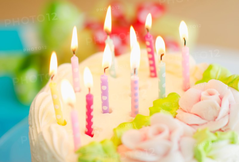 Illuminated candles on cake.