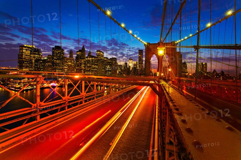 USA, New York City, Brooklyn Bridge with light trails at dusk.