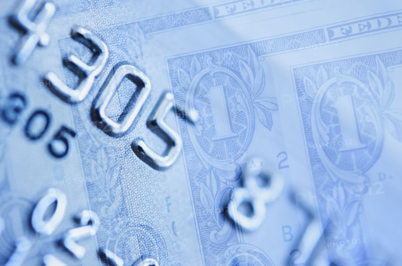 Credit card and dollar bills, studio shot.