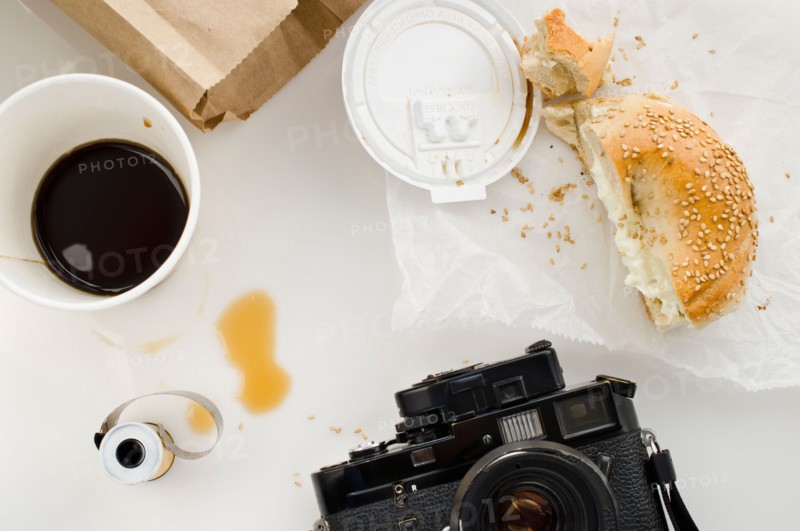 Breakfast and camera on table, studio shot.
