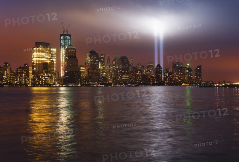 USA, New York City, Manhattan skyline with 9/11 memorial lights.