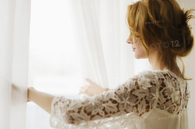 Woman looking out window.