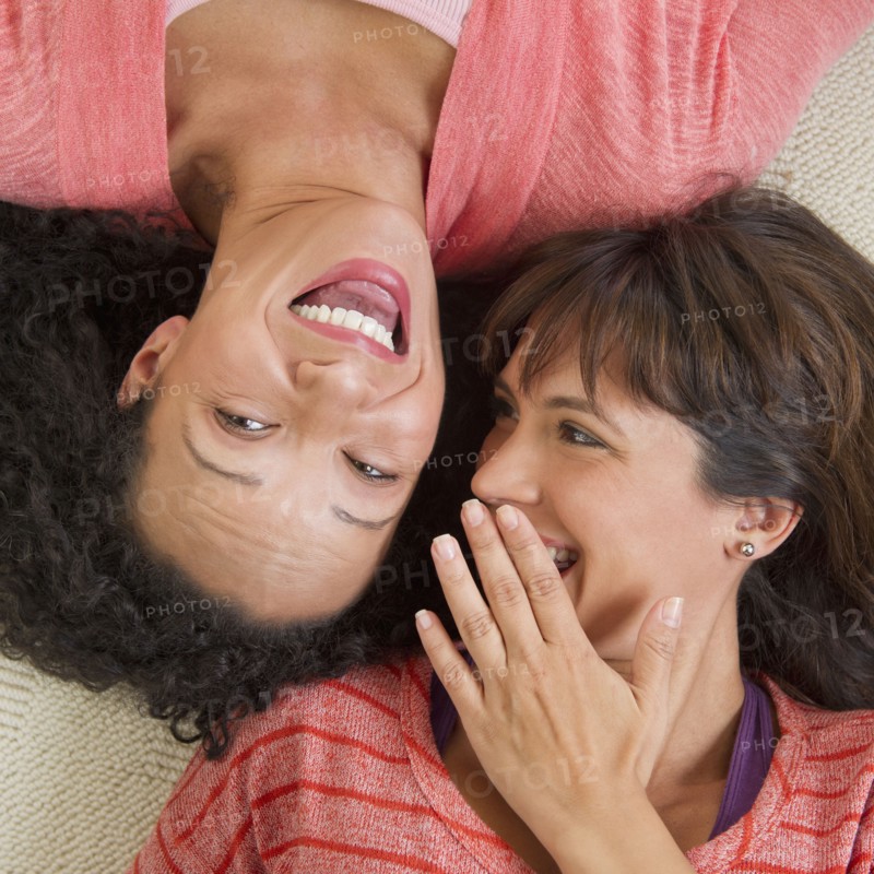 Women lying down and laughing.