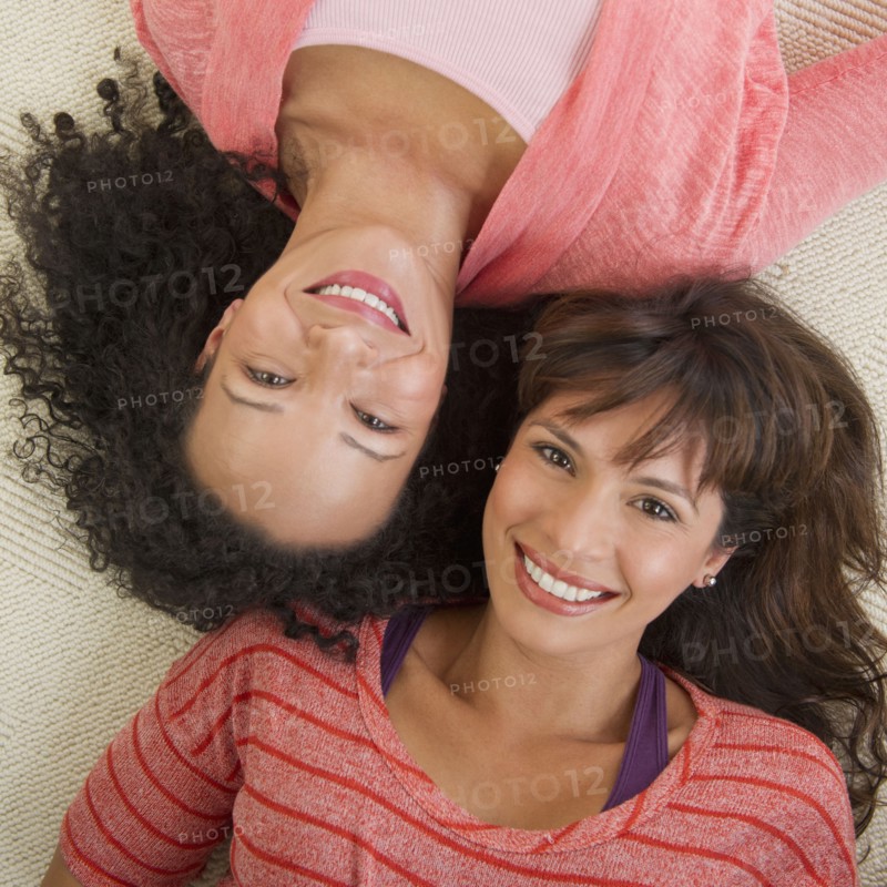 Portrait of women lying on floor.