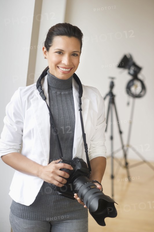 Portrait of woman with digital camera.