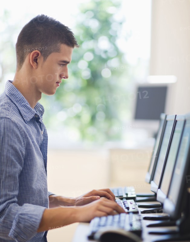 Teenage student (16-17) in computer lab.