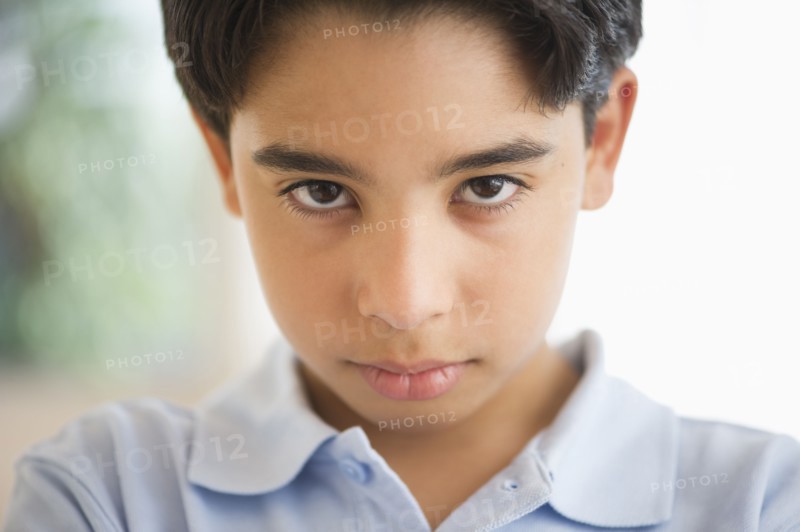 Portrait of angry boy (12-13).