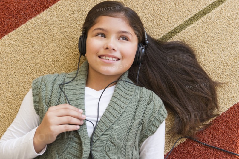 Girl (10-11) listening music .