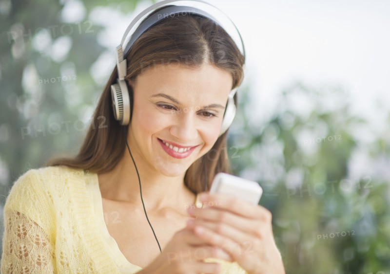 Woman with headphones outdoors.