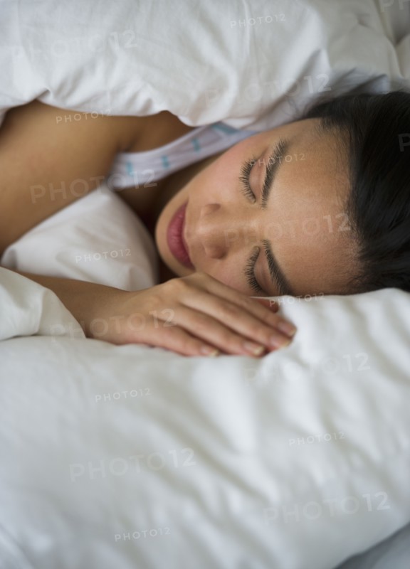 Woman sleeping in bed.