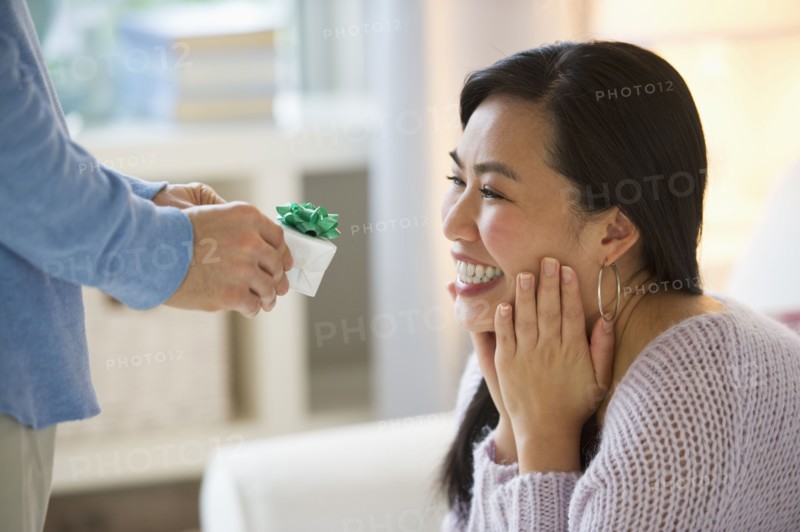 Man giving to woman engagement ring.