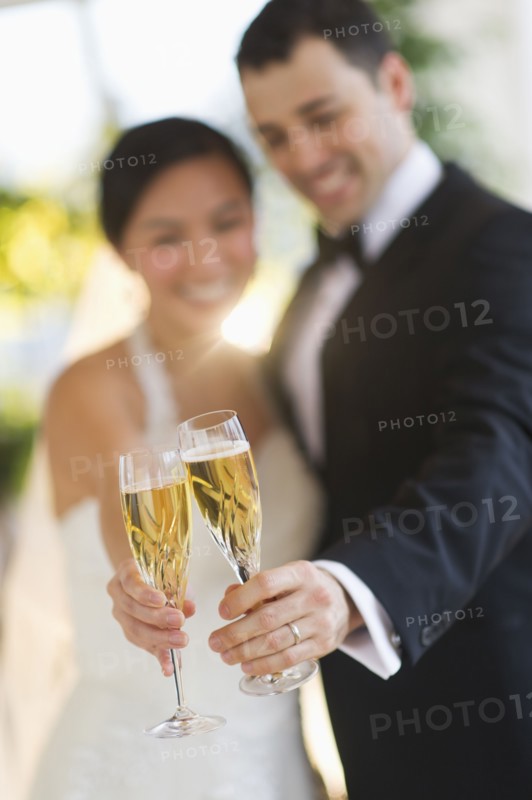 Bride and groom toasting with champagne.