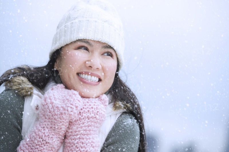 Portrait of happy woman wearing warm clothing.