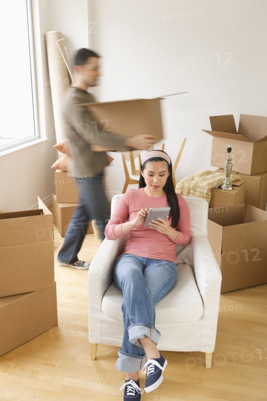 Man and woman unpacking things in new house.