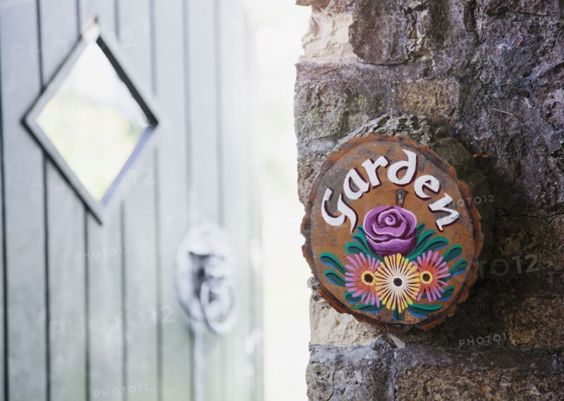 Ireland, County Westmeath, Garden sign on stone wall. Photo: Jamie Grill