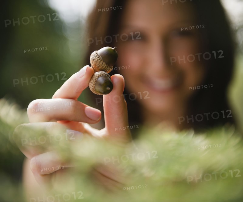 Roaring Brook Lake, Close up of woman's hand holding acorns. Photo: Jamie Grill