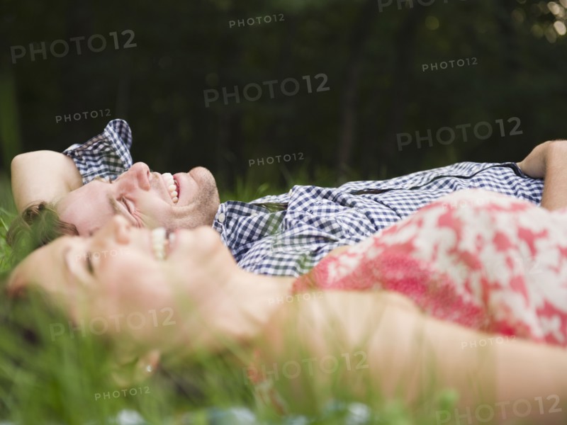 Roaring Brook Lake, Couple lying on grass. Photo: Jamie Grill