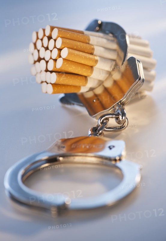 Close up of bunch of cigarettes locked in handcuffs. Photo: Daniel Grill