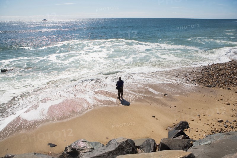 USA, New York, Long Island, Montaurk, Man fishing in sea. Photo: fotog