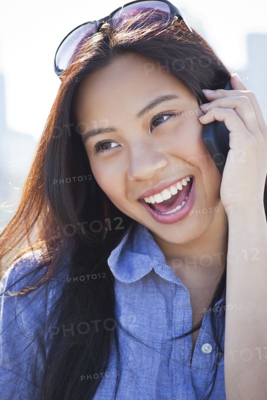 Woman talking on mobile phone outdoors. Photo: Take A Pix Media
