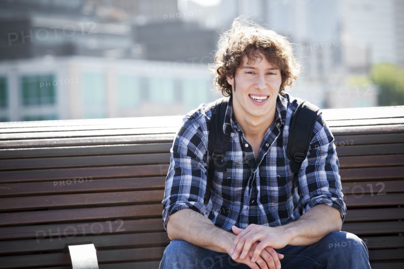 USA, Washington, Seattle, Young man sitting on bench. Photo : Take A Pix Media