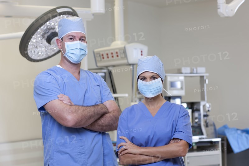 Portrait of male and female surgeons in operating room. Photo : db2stock