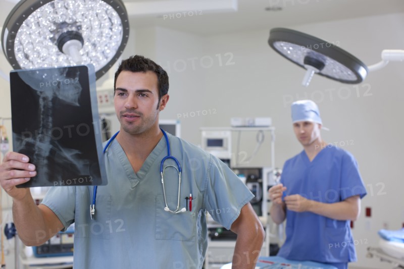 Doctor looking at x-ray. Photo : db2stock
