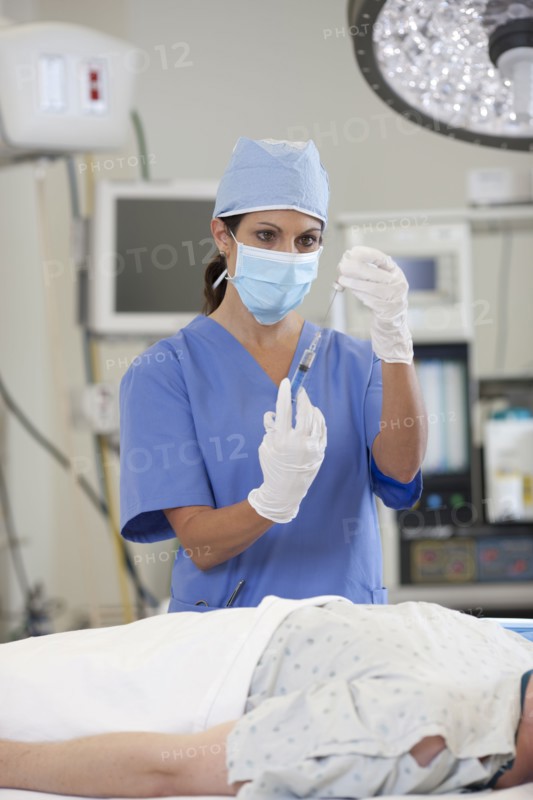 Surgeon preparing patient for surgery. Photo : db2stock