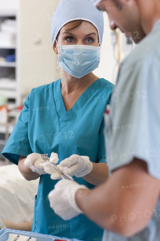 Surgeons holding tools. Photo: db2stock