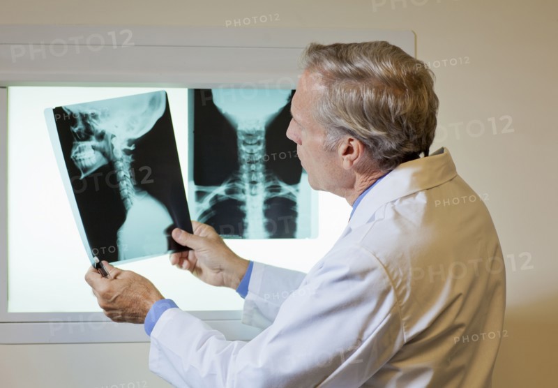 Doctor looking at x-ray. Photo : db2stock