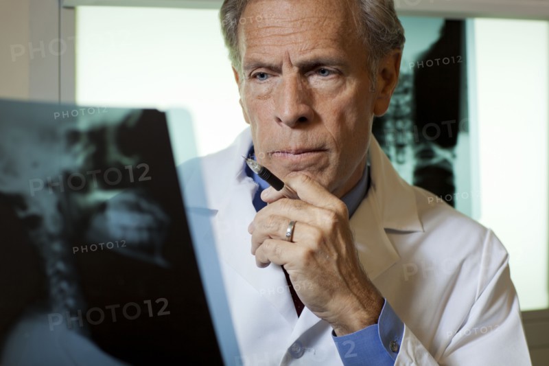 Doctor looking at x-ray. Photo : db2stock
