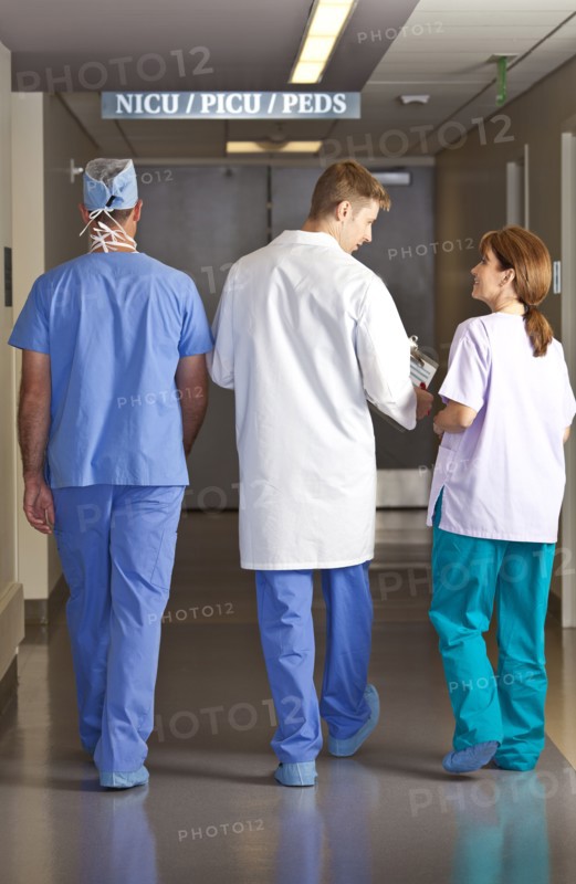 Doctors and surgeons walking in corridor. Photo : db2stock