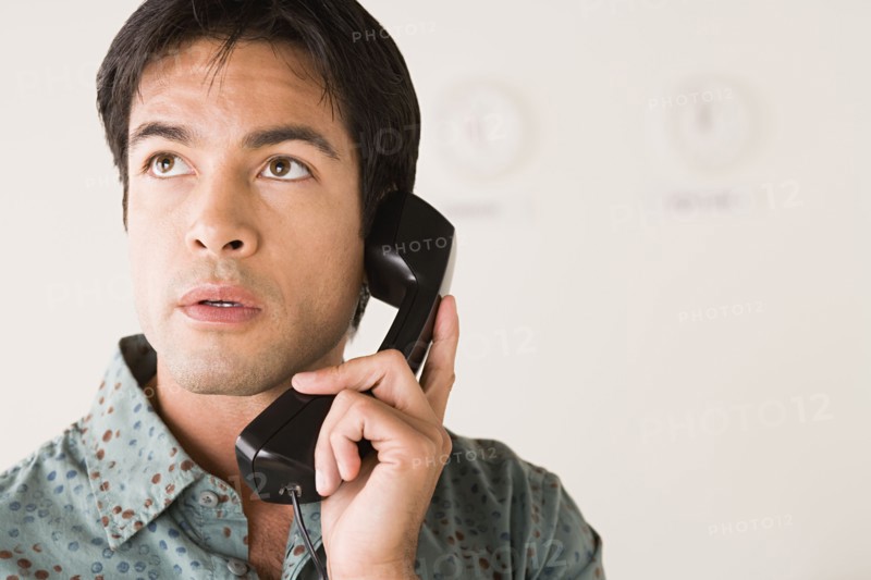 Businessman talking on phone. Photo : Rob Lewine