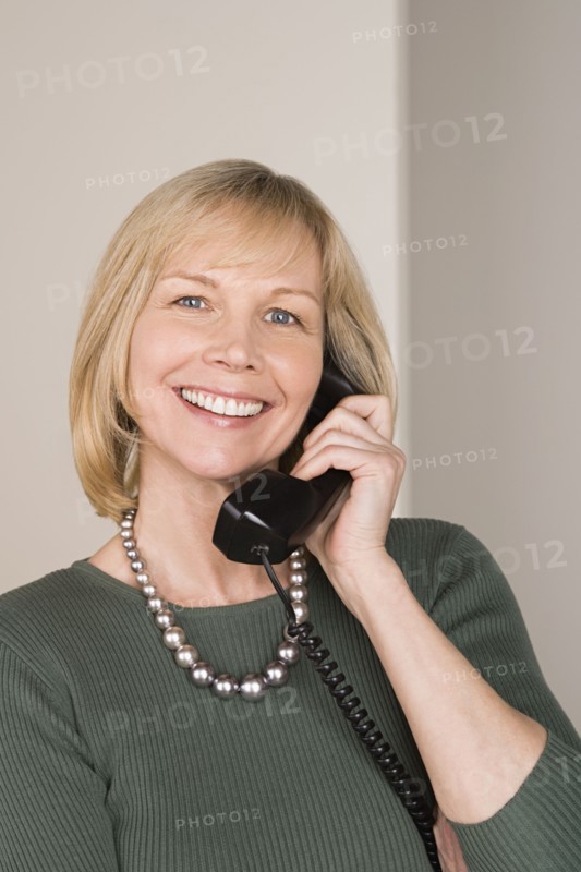 Portrait of businesswoman talking on phone. Photo : Rob Lewine