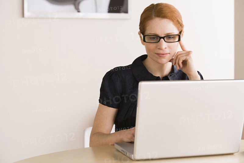 Businesswoman using laptop. Photo : Rob Lewine