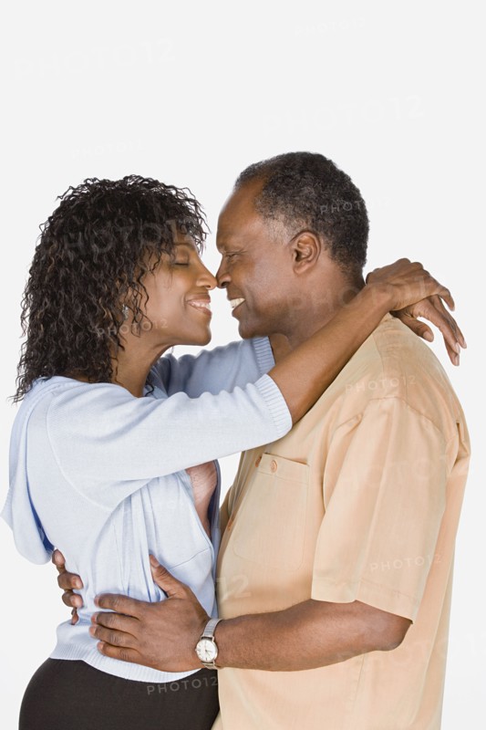 Studio shot of mature couple kissing. Photo : Rob Lewine