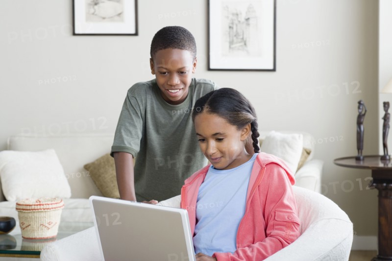 Brother and sister (10-13) using laptop. Photo: Rob Lewine