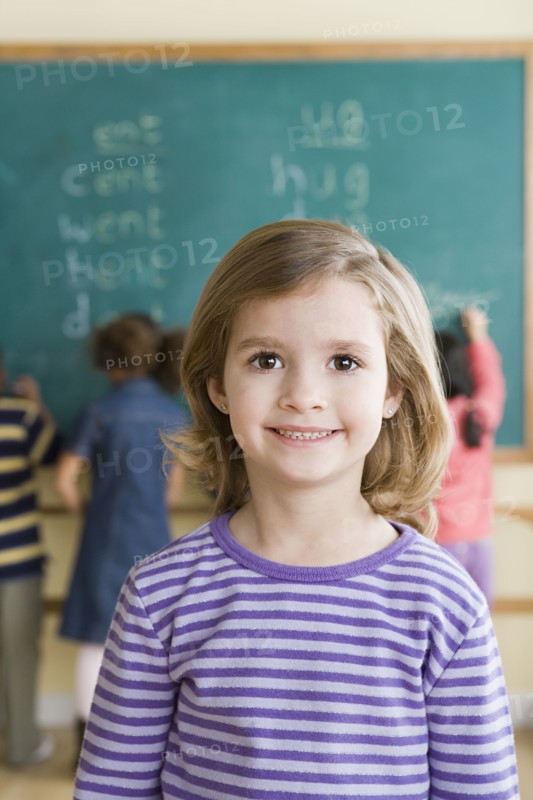Portrait of girl (6-7) in classroom. Photo : Rob Lewine