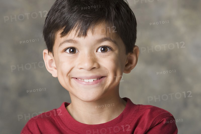 Portrait of smiling boy (8-9), studio shot. Photo : Rob Lewine