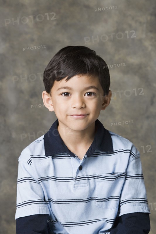 Portrait of smiling boy (8-9), studio shot. Photo : Rob Lewine