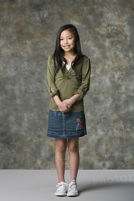 Portrait of smiling girl (8-9), studio shot. Photo: Rob Lewine